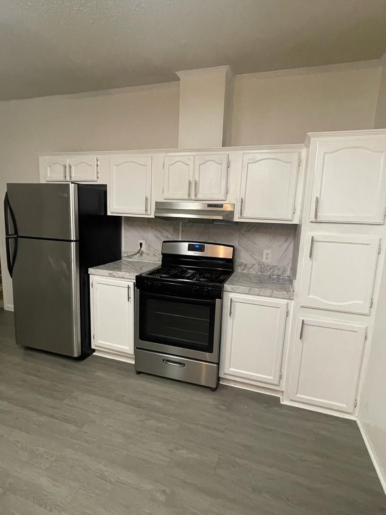 99 Partridge Lane Beecher, IL 60401 - Photo 7 of 22 a kitchen with a refrigerator and white cabinets