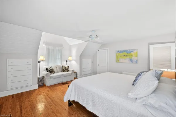 a bedroom with a bed and a couch