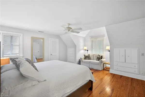 a bedroom with a large bed and furniture