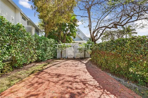 a view of a city with lawn chairs under an umbrella