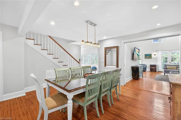 a view of a dining room with furniture and wooden floor