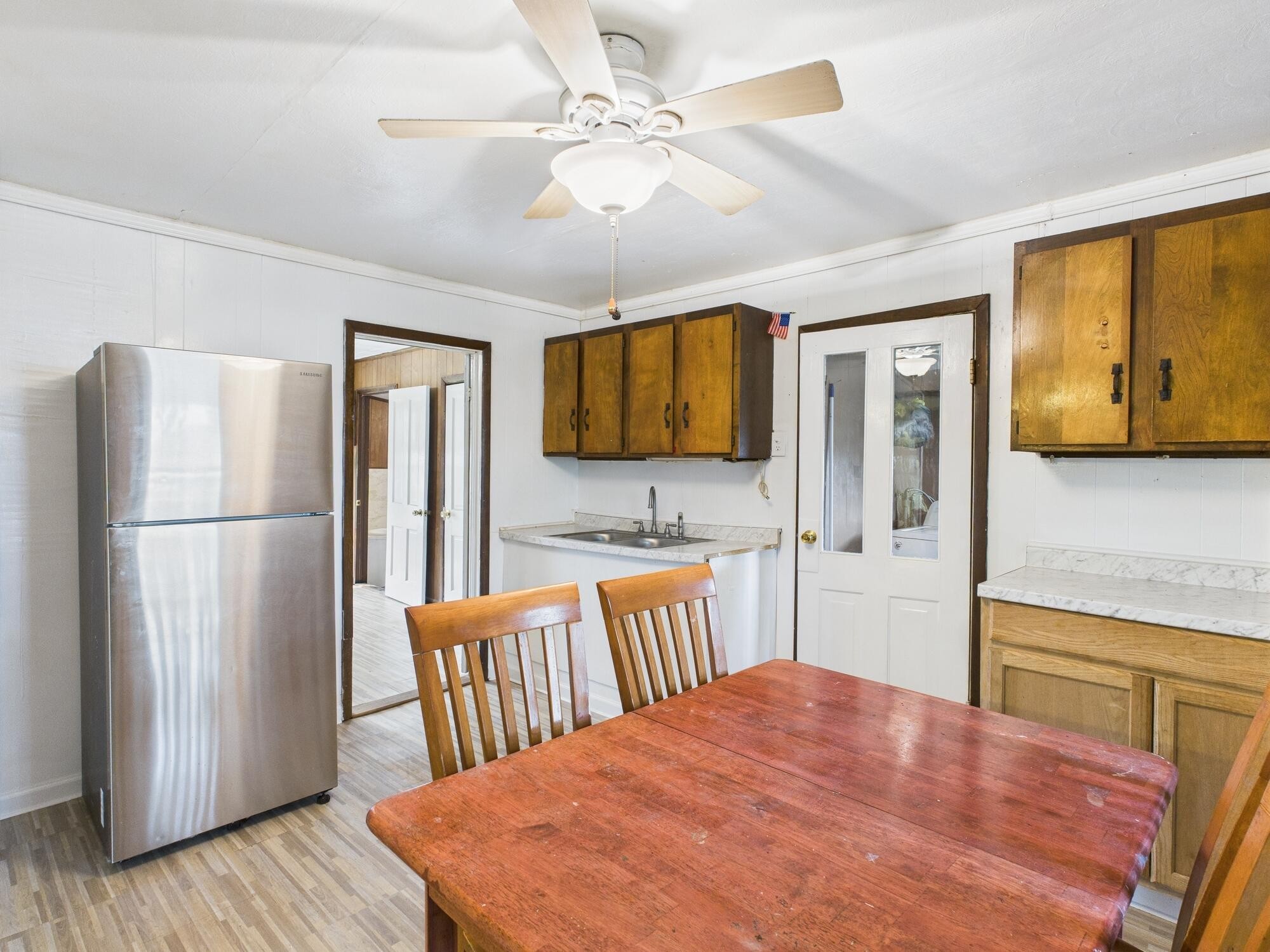 174 East Jackson Avenue Spring City, TN 37381 - Photo 11 of 28 a kitchen with stainless steel appliances granite countertop a refrigerator a microwave oven a sink dishwasher and white cabinets with wooden floor