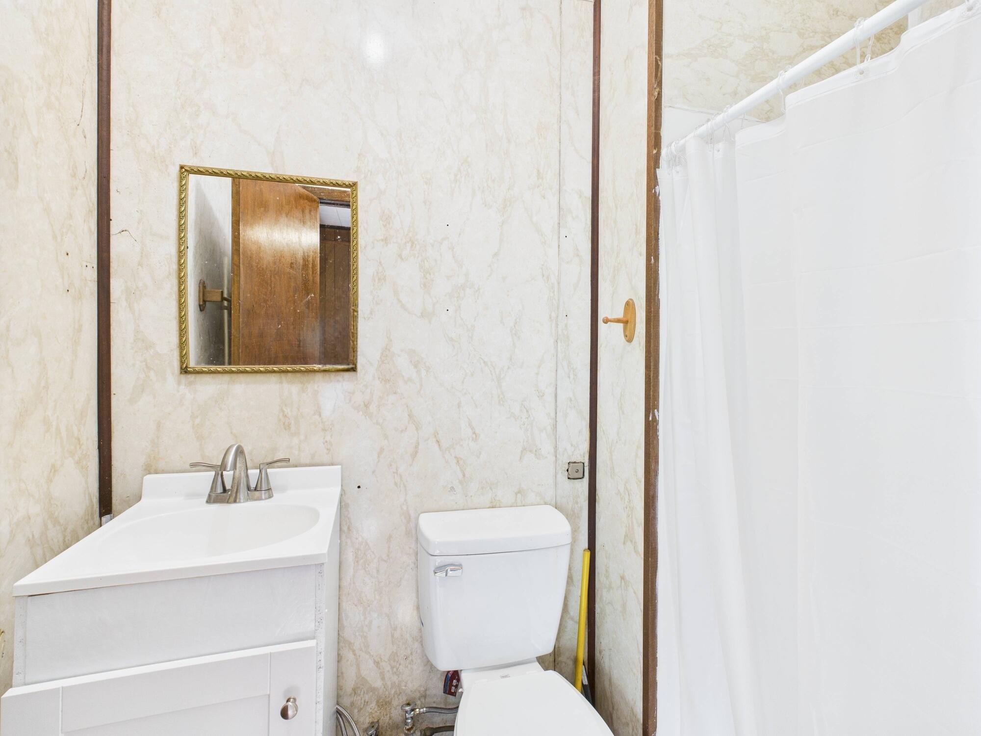 174 East Jackson Avenue Spring City, TN 37381 - Photo 22 of 28 a bathroom with a toilet sink and a mirror