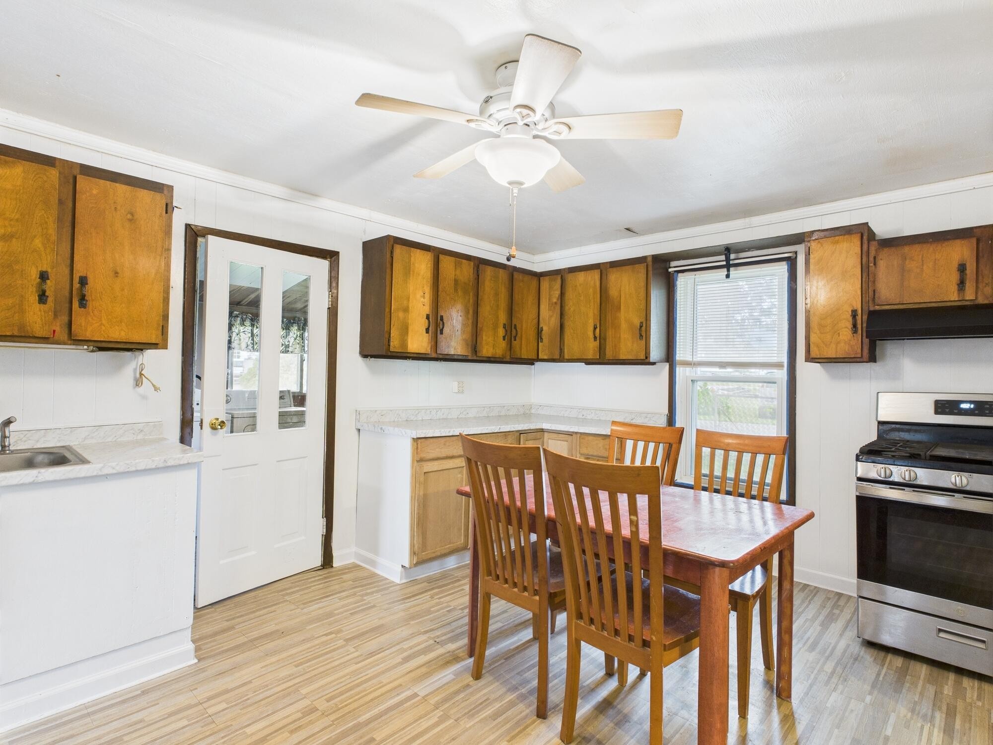 174 East Jackson Avenue Spring City, TN 37381 - Photo 10 of 28 a kitchen with stainless steel appliances kitchen island granite countertop a table chairs in it and wooden floors