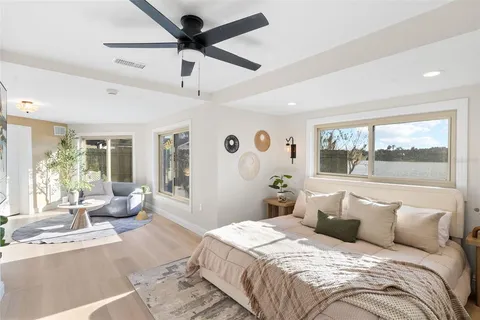 a bedroom with bed and glass window