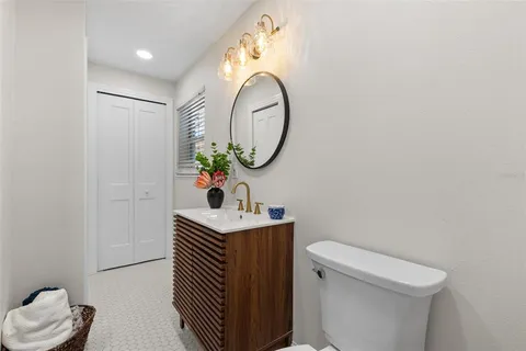 a bathroom with a toilet a sink and a mirror