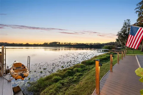 a view of a terrace with wooden floor and lake view
