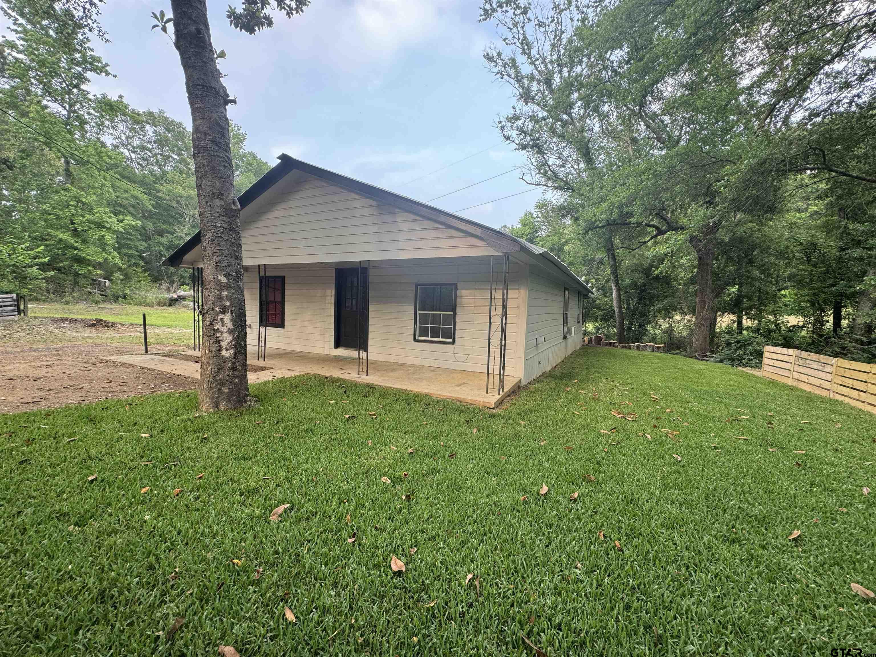 8124 County Road 381 Tyler, TX 75708 - Photo 1 of 23 a view of a house with backyard and garden