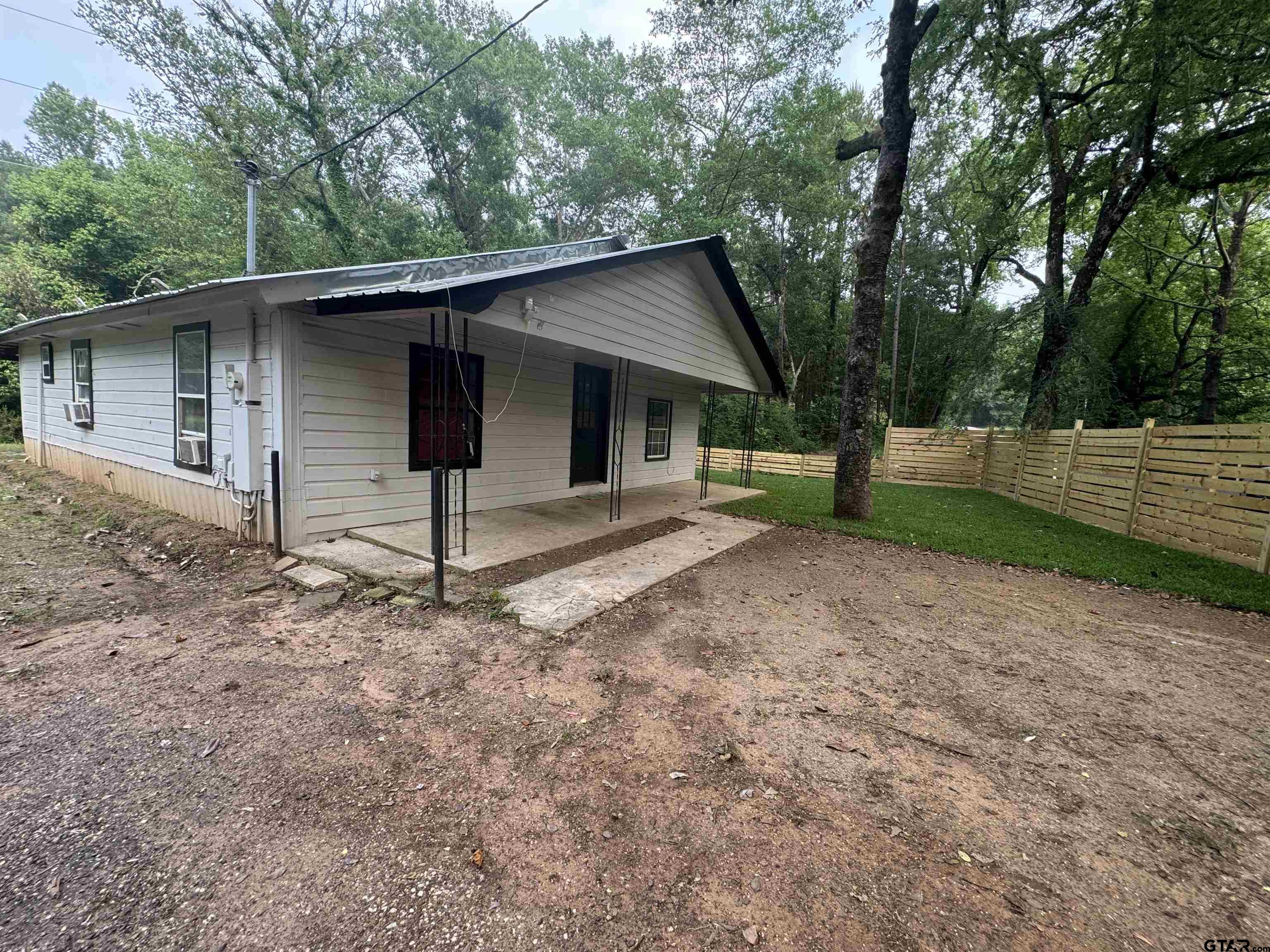 8124 County Road 381 Tyler, TX 75708 - Photo 11 of 23 a backyard of a house with barbeque oven