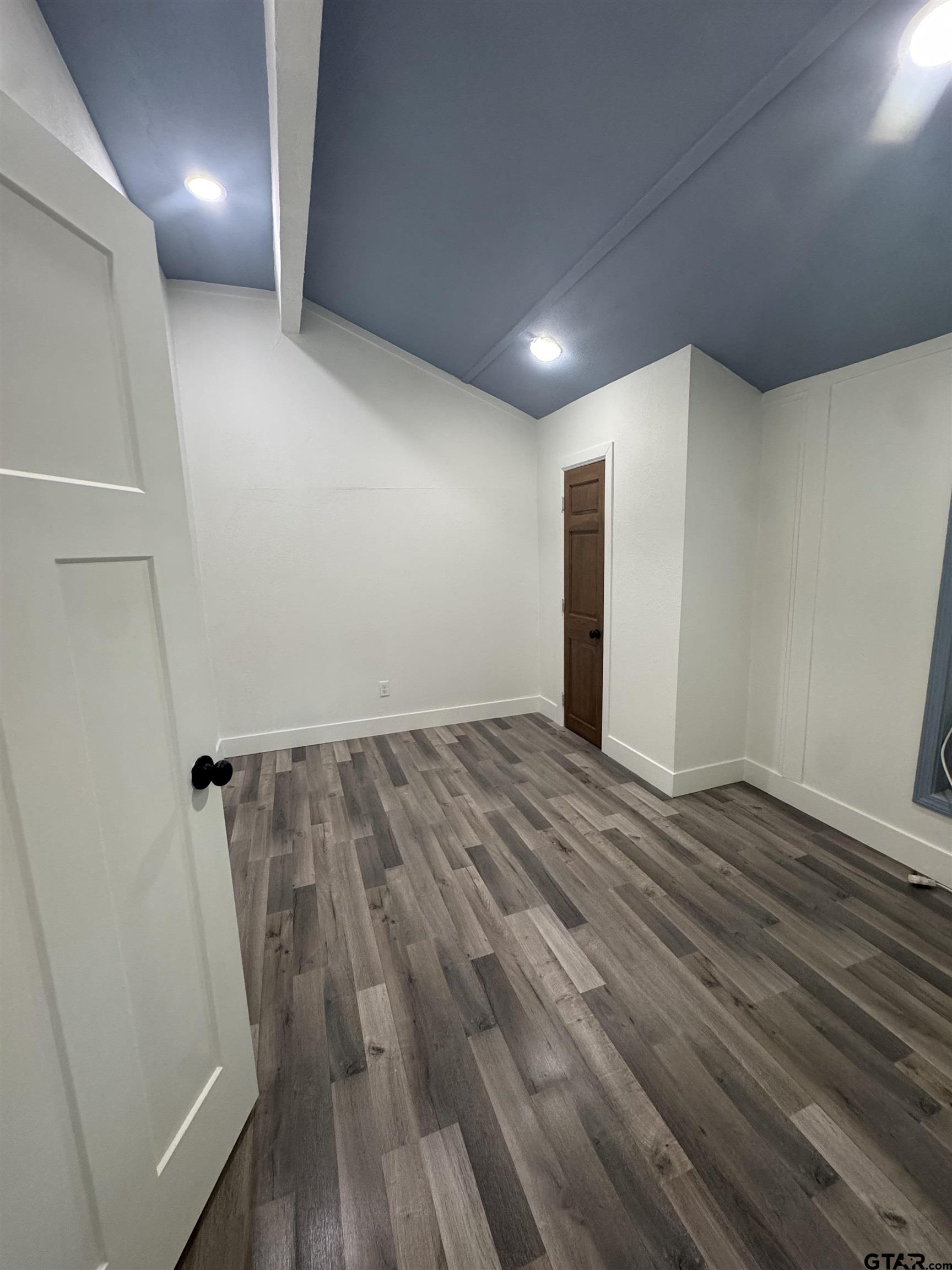 8124 County Road 381 Tyler, TX 75708 - Photo 15 of 23 an empty room with wooden floor and windows