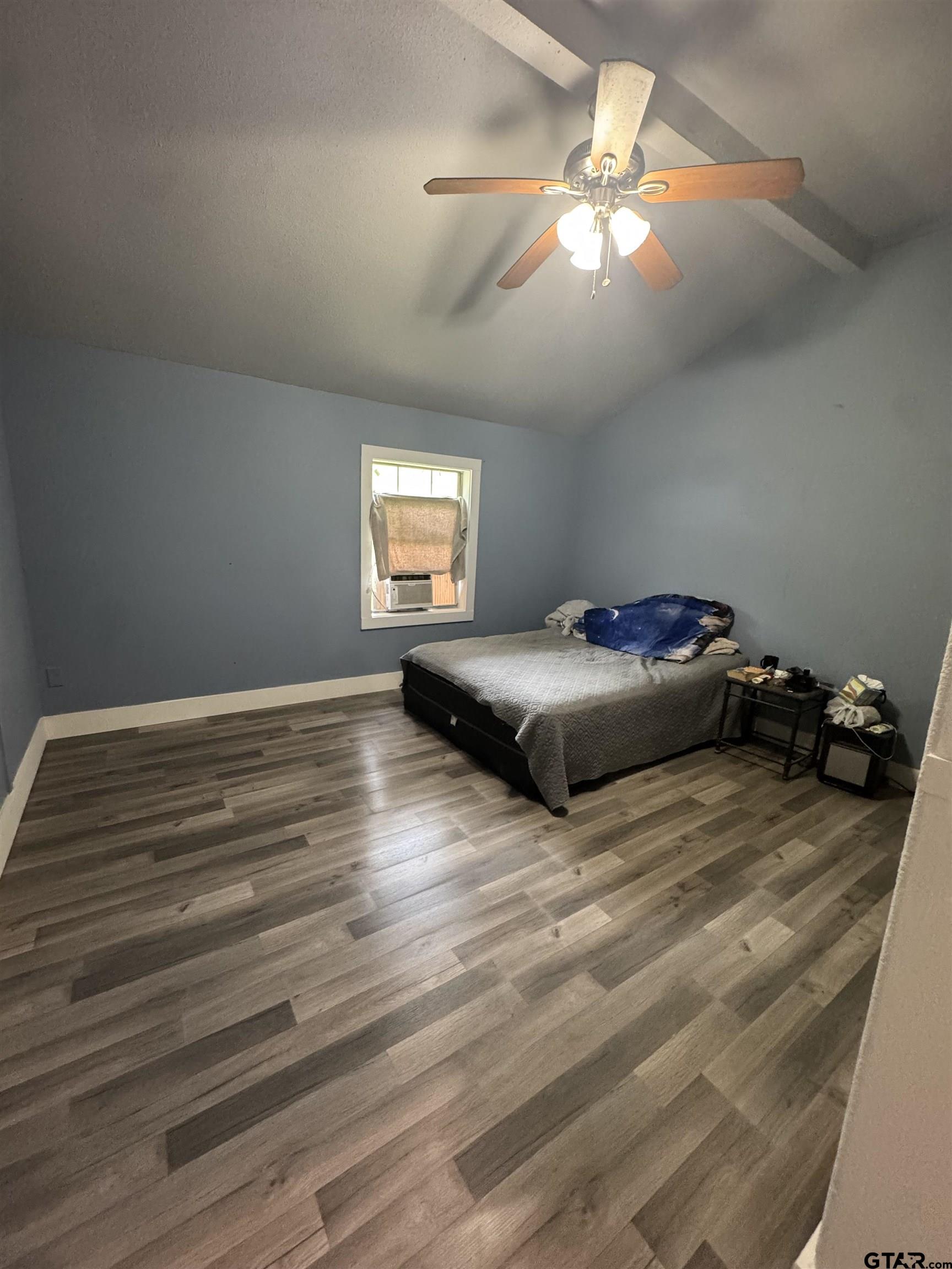 8124 County Road 381 Tyler, TX 75708 - Photo 16 of 23 a bedroom with a bed and a chandelier