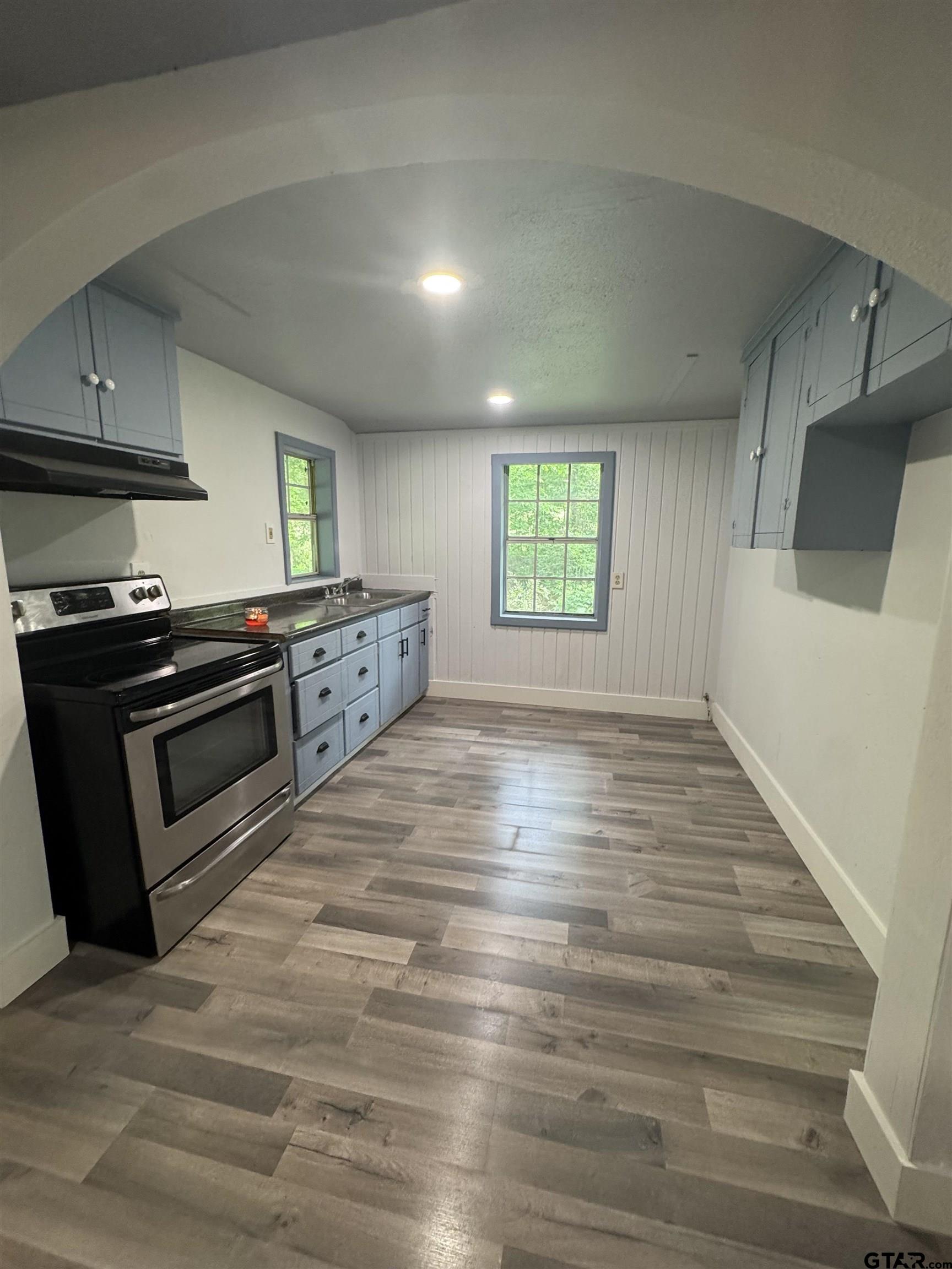 8124 County Road 381 Tyler, TX 75708 - Photo 19 of 23 a kitchen with stainless steel appliances granite countertop a stove a sink and a microwave