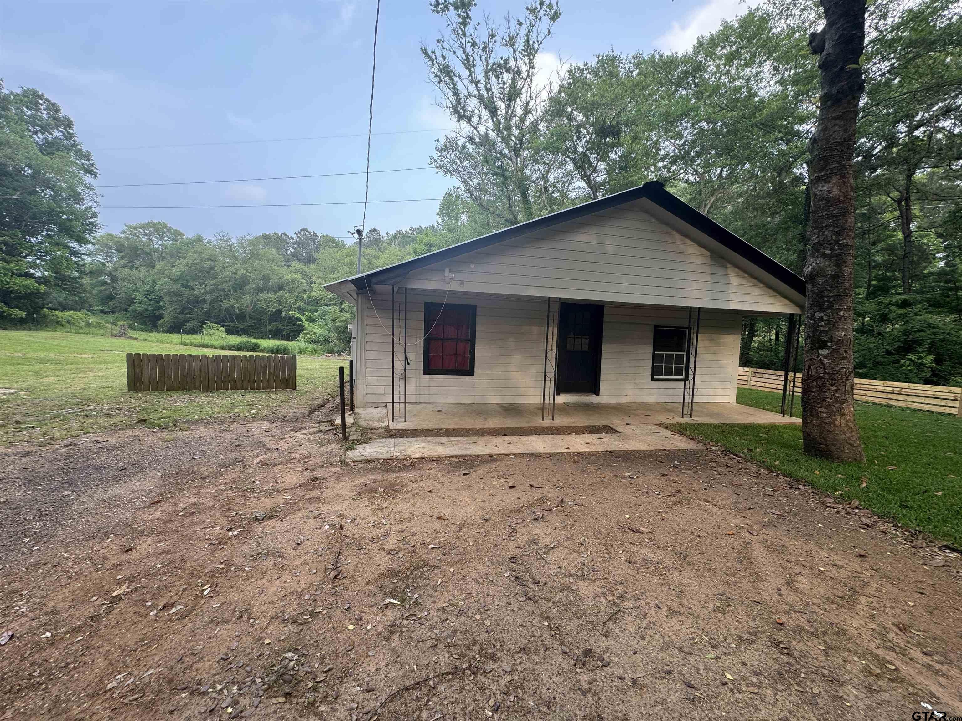 8124 County Road 381 Tyler, TX 75708 - Photo 2 of 23 a house with a yard