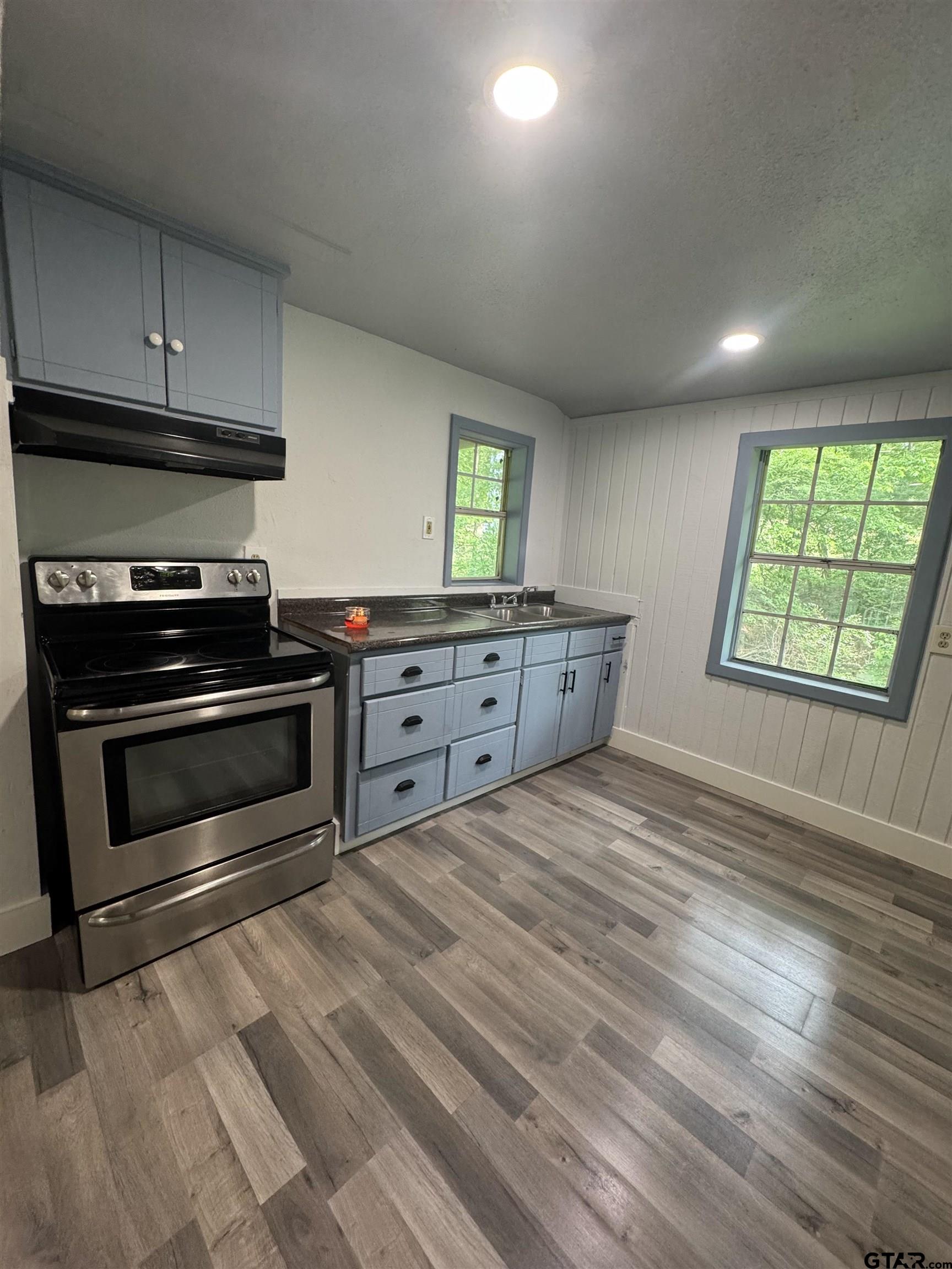 8124 County Road 381 Tyler, TX 75708 - Photo 21 of 23 a kitchen with stainless steel appliances a stove and a wooden floors