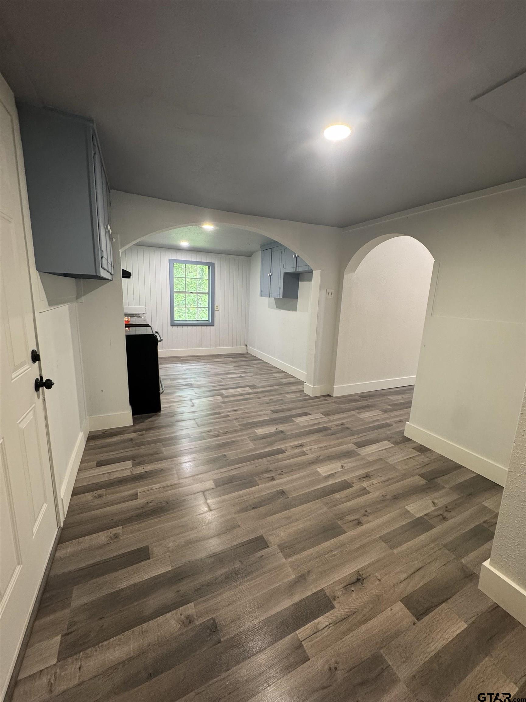 8124 County Road 381 Tyler, TX 75708 - Photo 23 of 23 an empty room with wooden floor and windows