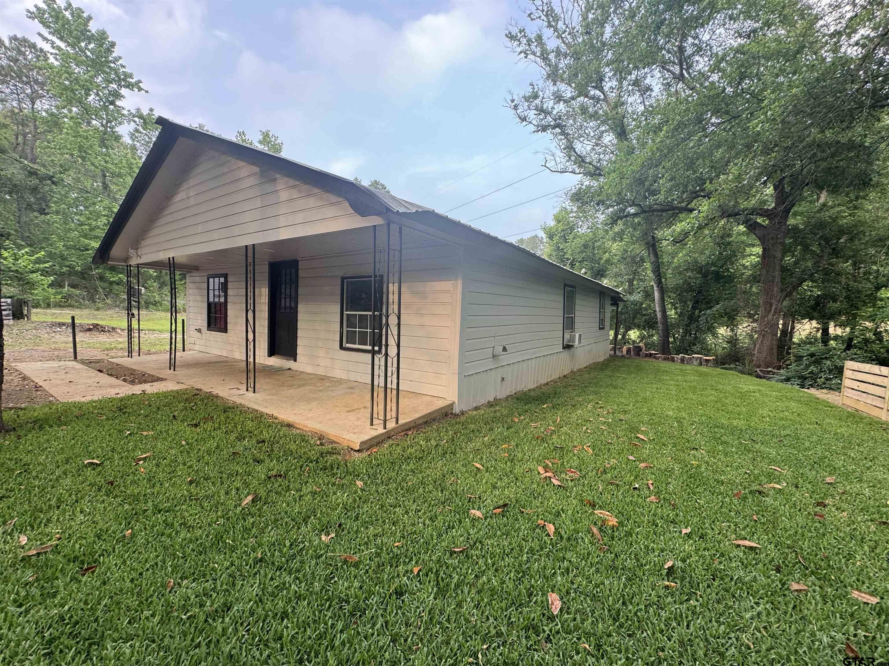 8124 County Road 381 Tyler, TX 75708 - Photo 5 of 23 a view of a house with backyard and garden