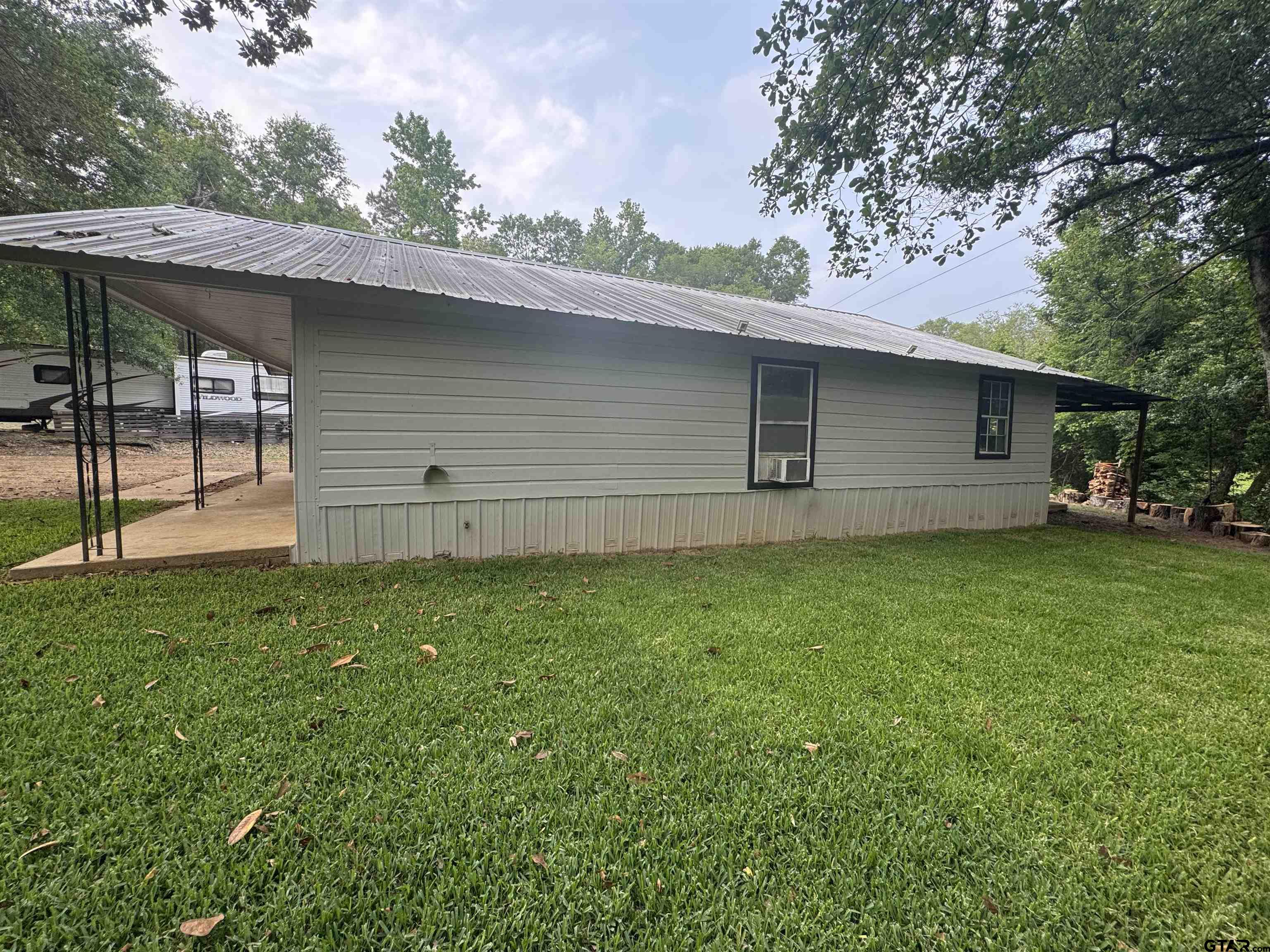8124 County Road 381 Tyler, TX 75708 - Photo 6 of 23 a backyard of a house with lots of green space