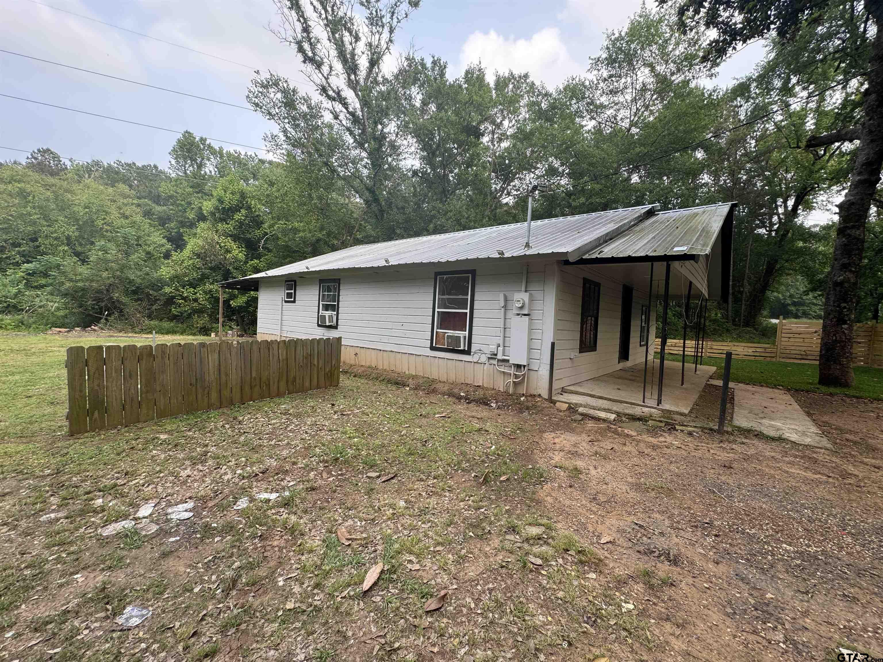 8124 County Road 381 Tyler, TX 75708 - Photo 7 of 23 a view of a house with a backyard