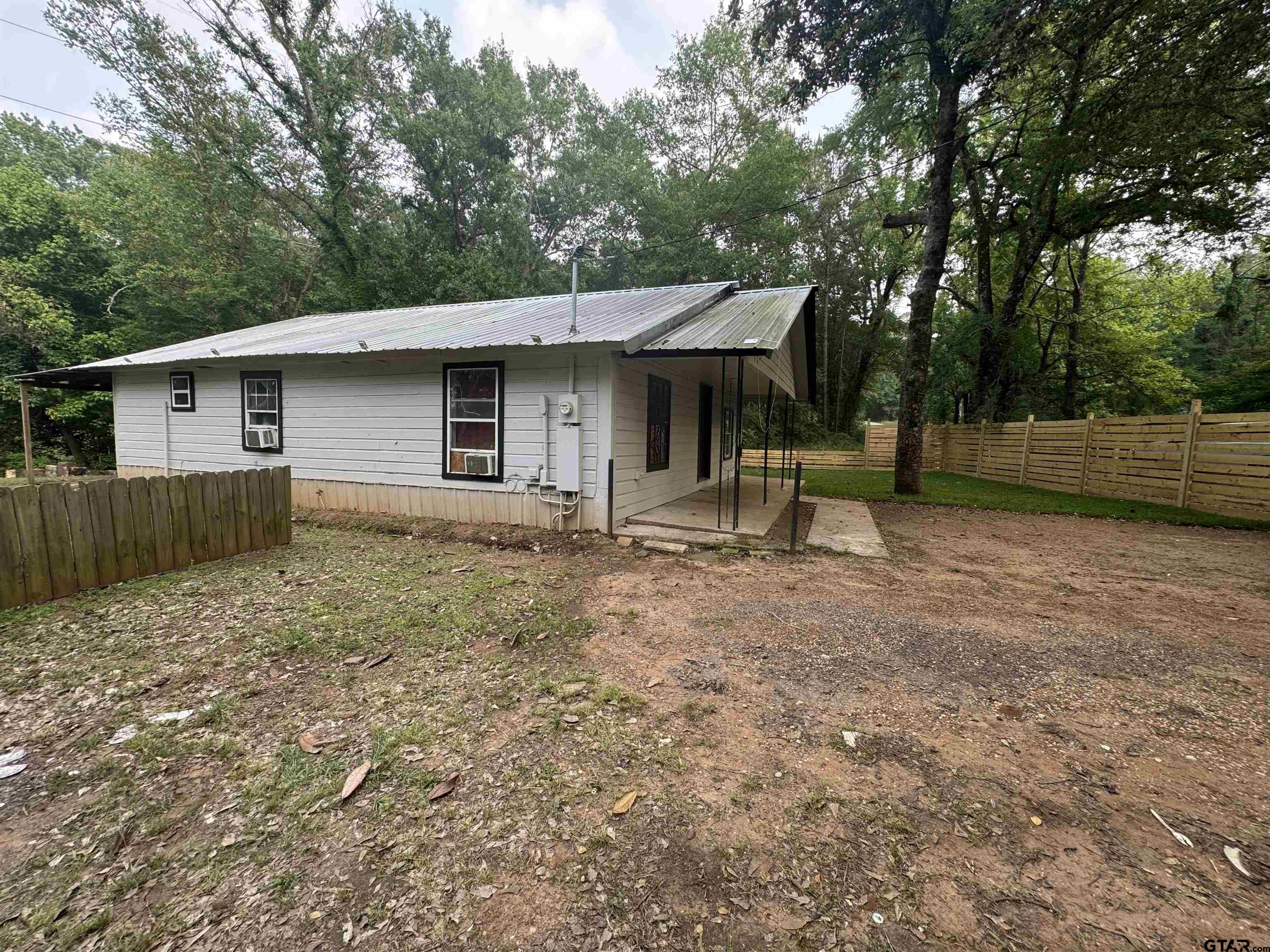8124 County Road 381 Tyler, TX 75708 - Photo 8 of 23 a backyard of a house with table and chairs