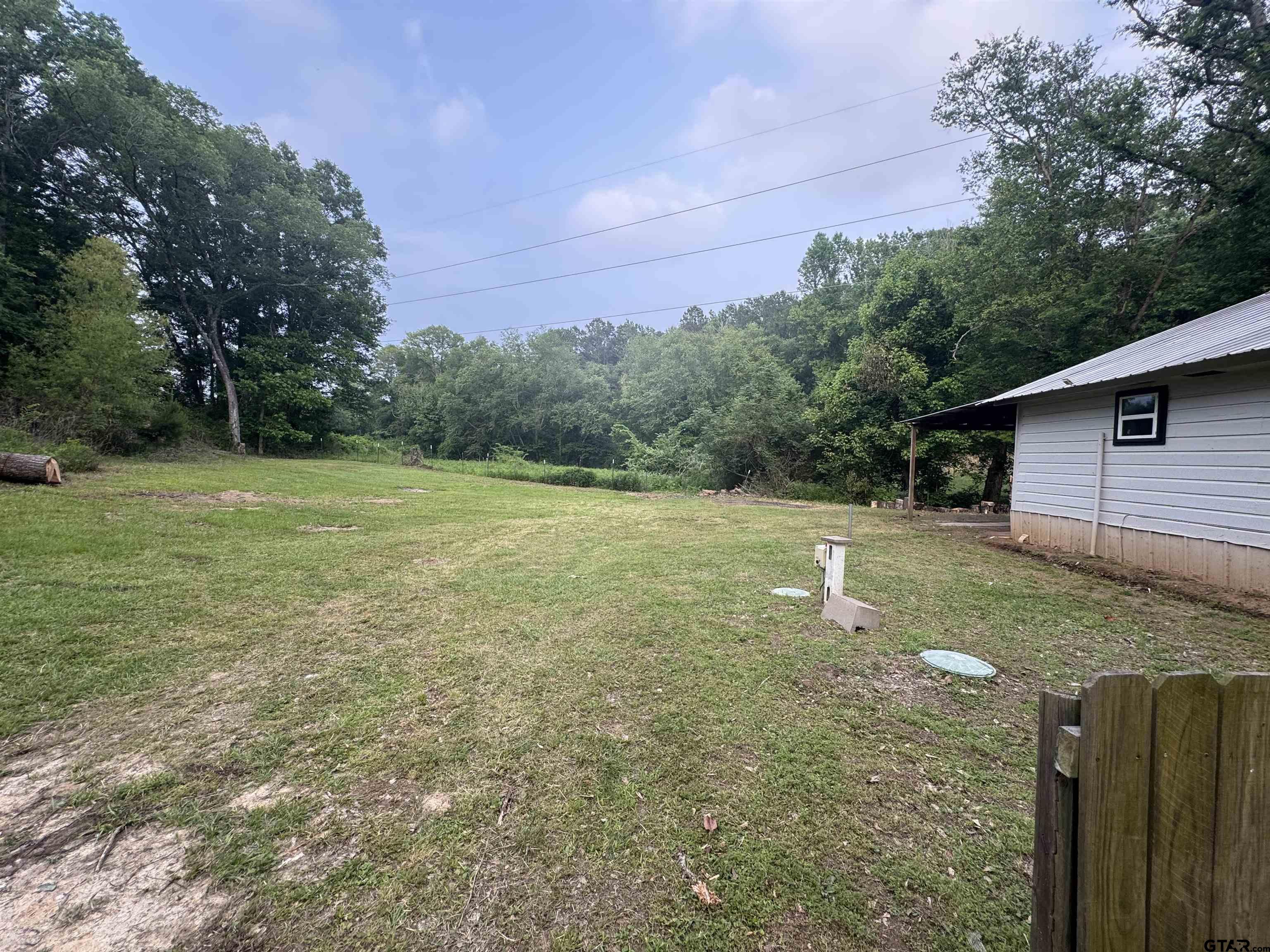 8124 County Road 381 Tyler, TX 75708 - Photo 10 of 23 a backyard of a house with lots of green space