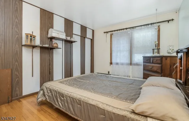 a bedroom with a large bed and a dresser