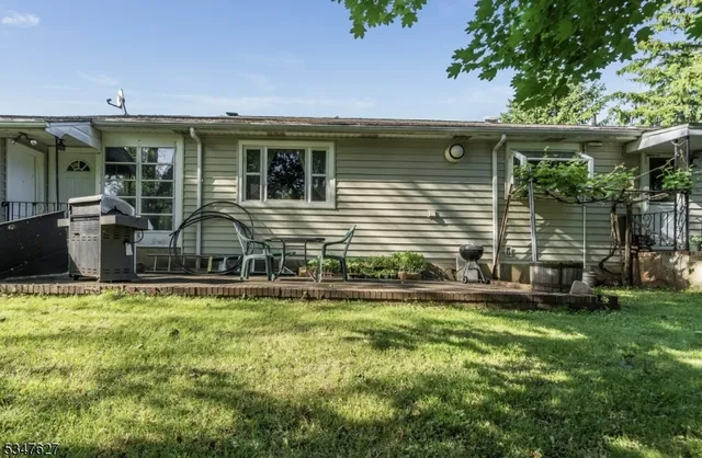 a front view of house with yard and outdoor seating
