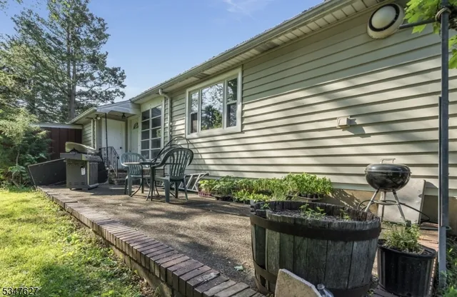 a view of a house with backyard and sitting area