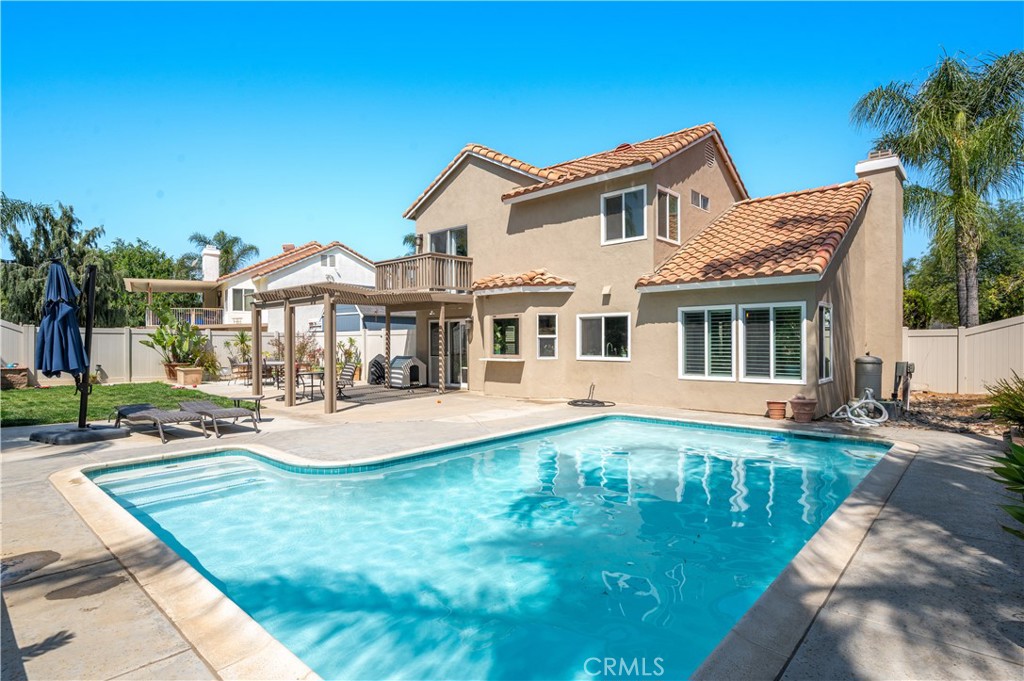 19465 Kinnow Lane Riverside, CA 92508 - Photo 43 of 61 a front view of a house with swimming pool having outdoor seating