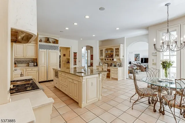 a kitchen with stainless steel appliances a refrigerator sink and cabinets