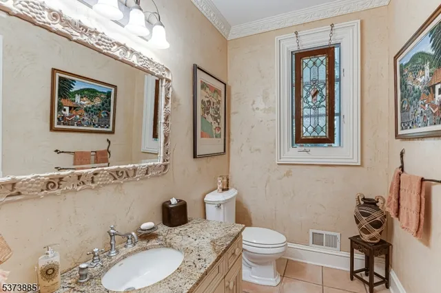 a living room with furniture a chandelier and a flat screen tv