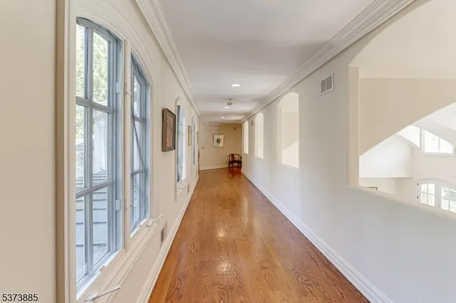 a spacious bedroom with a large bed a flat screen tv and a couch