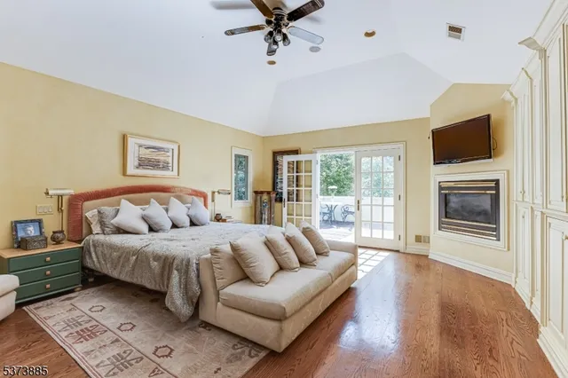 a roof deck with table and chairs and potted plants