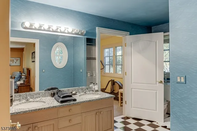 a bathroom with a sink a mirror and a shower