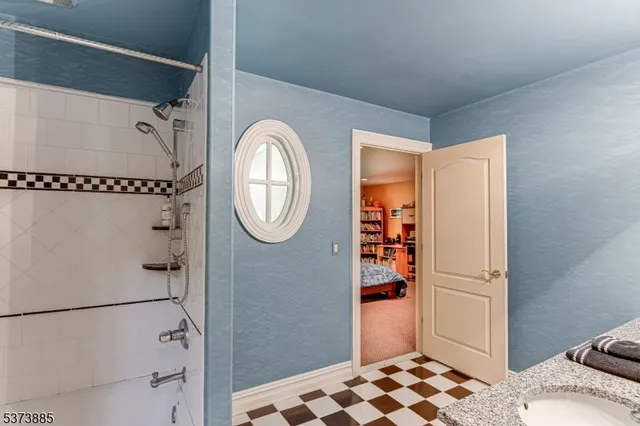 a view of a bathroom with a sink a mirror and a bath tub