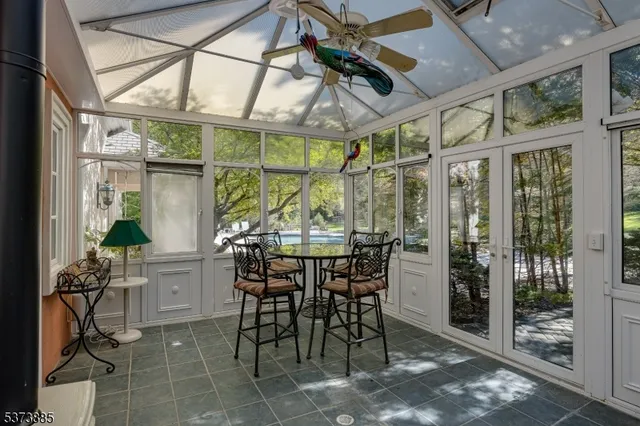 a view of a porch with chairs and potted plants
