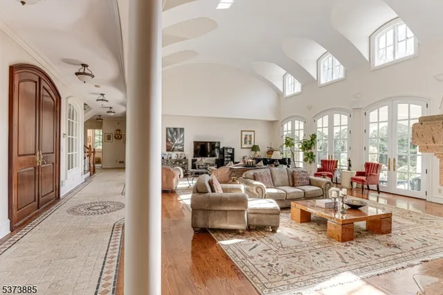 a living room with furniture fireplace and a large window