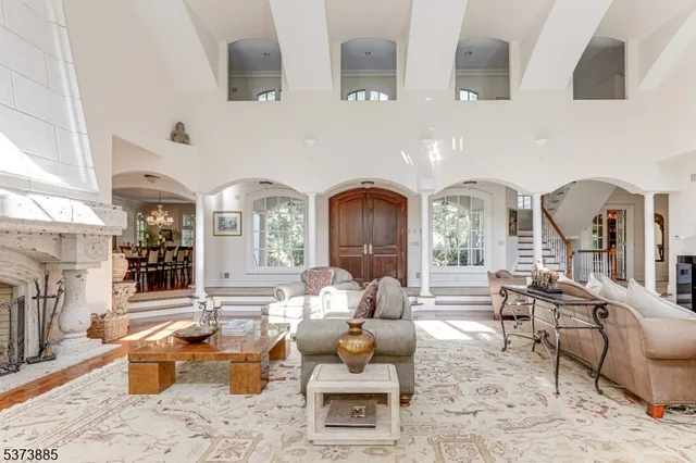 a living room with furniture fireplace and a large window