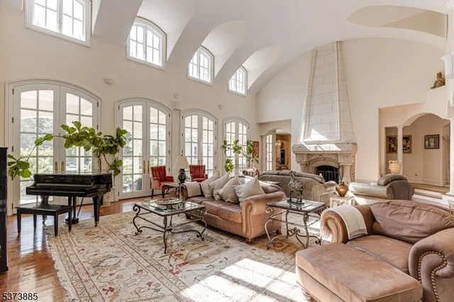 a living room with furniture fireplace and a chandelier
