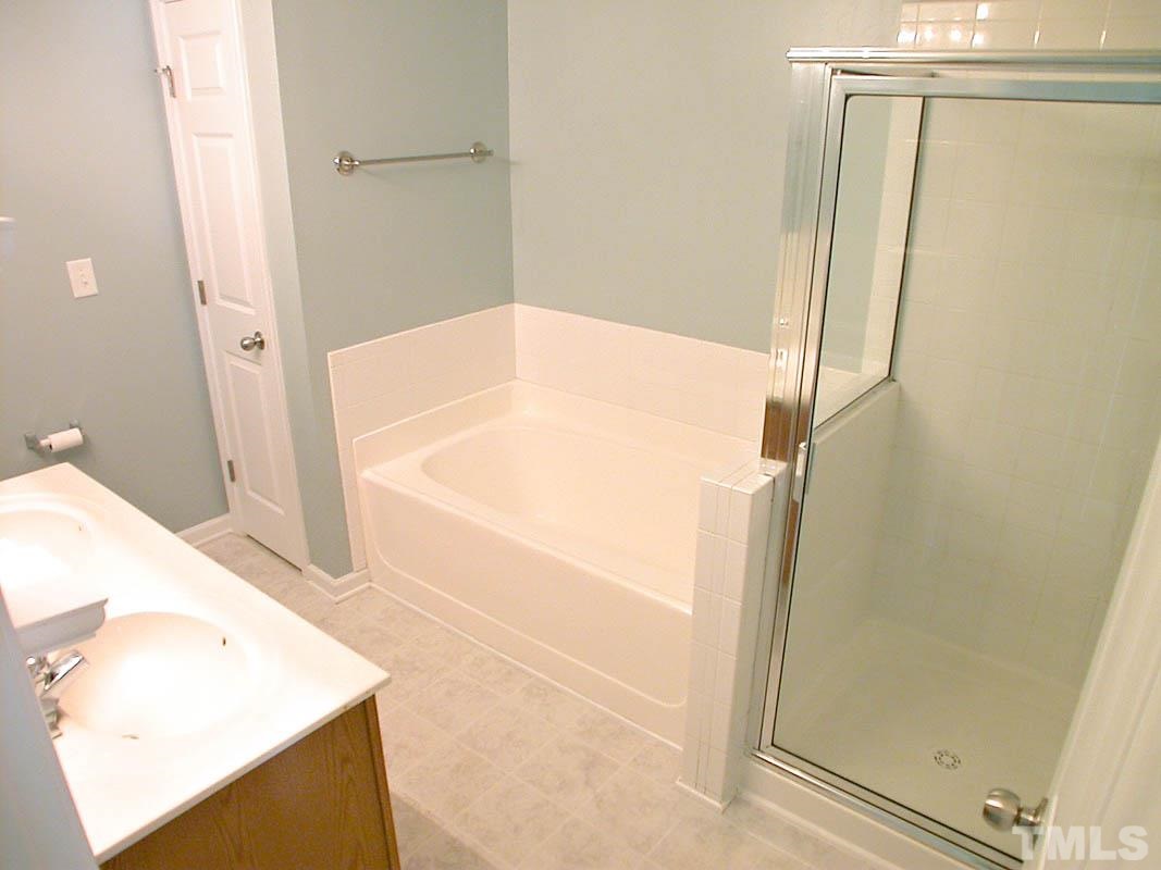 11710 Coppergate Drive, Unit 104 Raleigh, NC 27614 - Photo 13 of 14 a bathroom with a bathtub and a shower