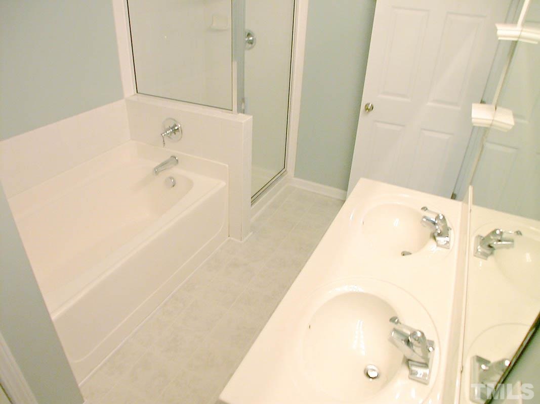 11710 Coppergate Drive, Unit 104 Raleigh, NC 27614 - Photo 14 of 14 a bathroom with a bathtub and shower