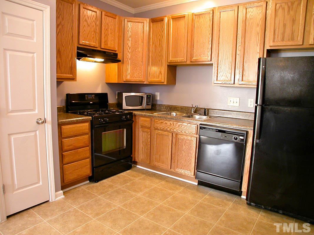11710 Coppergate Drive, Unit 104 Raleigh, NC 27614 - Photo 6 of 14 a kitchen with a stove sink and cabinets
