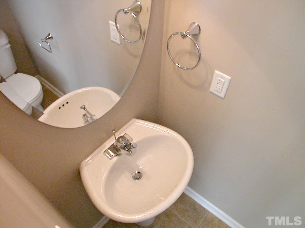 11710 Coppergate Drive, Unit 104 Raleigh, NC 27614 - Photo 7 of 14 a bathroom with a toilet and a mirror