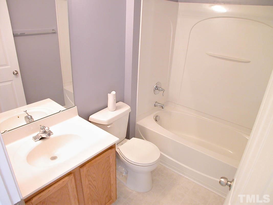 11710 Coppergate Drive, Unit 104 Raleigh, NC 27614 - Photo 10 of 14 a bathroom with a sink a toilet and bathtub