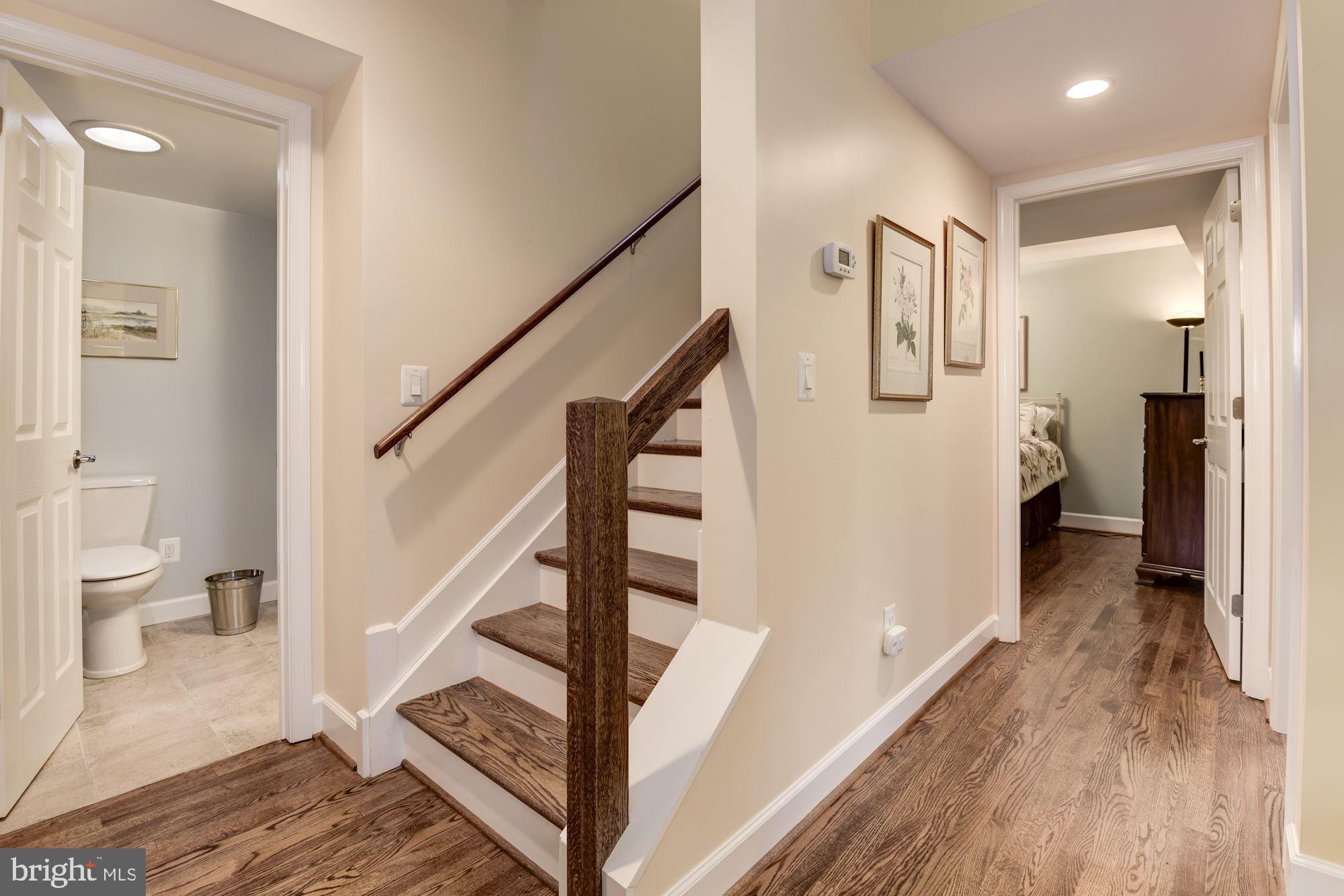 8006 New Market Road Alexandria, VA 22308 - Photo 26 of 37 Hardwood Stairs to the Upper Level. Skylight over