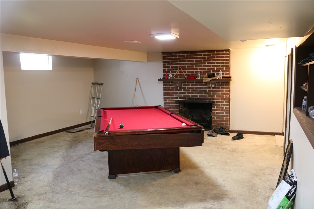 3185 Stop 8 Road Dayton, OH 45414 - Photo 5 of 10 This spacious basement offers ample room for recreation and a cozy fireplace for relaxation.