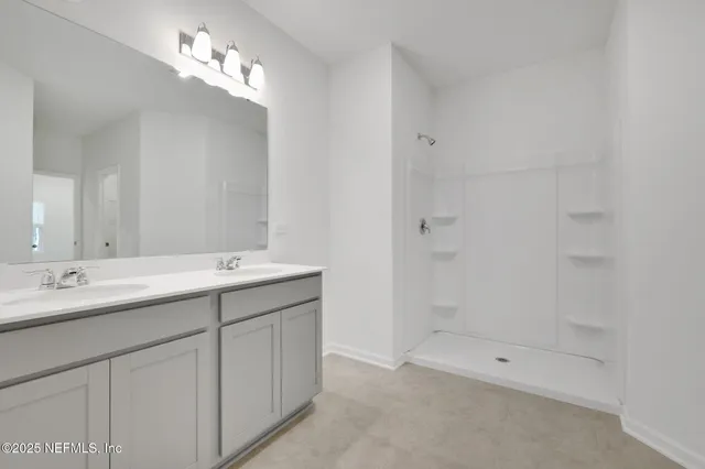 a bathroom with a double vanity sink and mirror