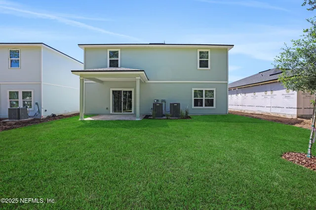 a view of a house with a backyard