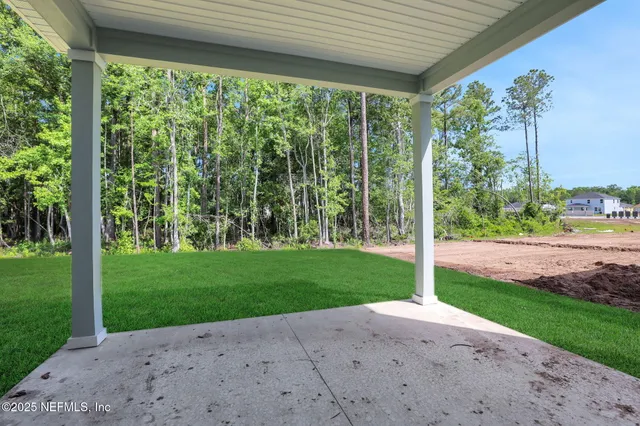 a view of a house with backyard and porch
