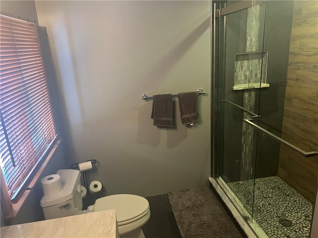 274 Alpine Heights Road Champion, PA 15622 - Photo 16 of 34 a bathroom with a granite countertop toilet and a shower