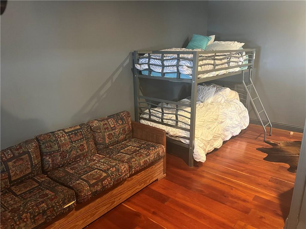 274 Alpine Heights Road Champion, PA 15622 - Photo 25 of 34 a living room with a bed furniture and a wooden floor